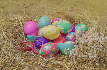 Eggs in the hay nest. Colorful easter eggs in a nestの写真素材
