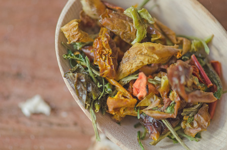 Spices in the spoon on wooden background. Mixture of dried vegetablesの写真素材