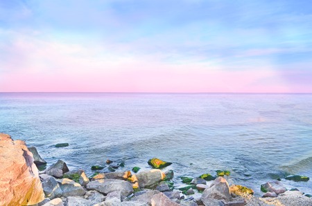 Sunset on the beach.  Pink horizon with first  sun rays.の写真素材