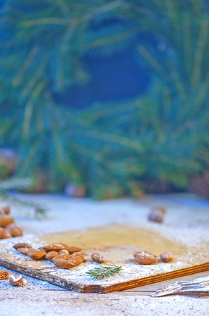 Christmas tree branches cones and nuts. Christmas wooden background with natural decoration with copy space.の写真素材