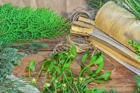 Christmas tree branches cones and nuts. Christmas wooden background with natural decoration の写真素材