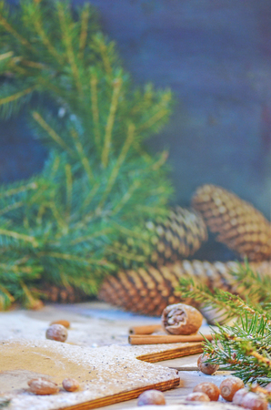 Christmas tree branches cones and nuts. Christmas wooden background with natural decoration with copy space.の写真素材