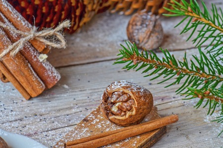 Christmas tree branches cones and nuts. Christmas wooden background with natural decoration の写真素材