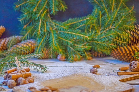Christmas tree branches cones and nuts. Christmas wooden background with natural decoration 