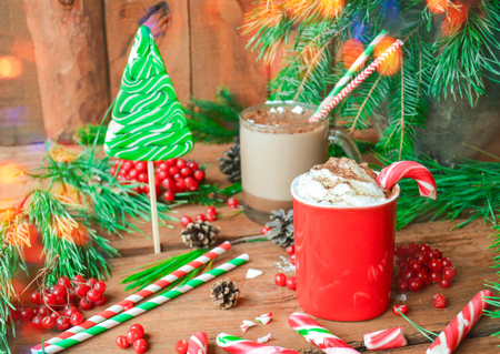 Cup of tasty cocoa on blurred background. Hot chocolate with marshmallows and candy cane. Hot chocolate with peppermint candiesの写真素材