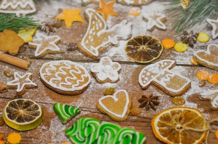 Christmas cookies, candy, fir festive decoration. Gingerbread cookies, dry orange and spices