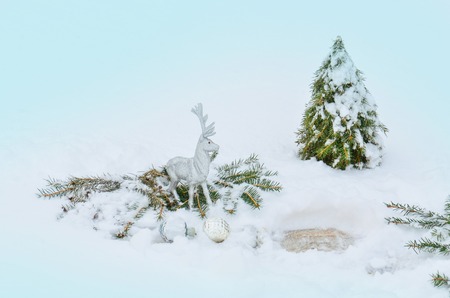Silver reindeer toy. Silver grey shiny Christmas reindeer at white snow background.  の写真素材