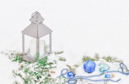 Lantern and balls in the snow. Lantern with Christmas decoration. Christmas lantern with snowfallの写真素材
