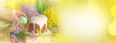 Decoration with eggs and Easter cake banner. Easter vintage style still life. Spring border or background art with bokeh golden shine light. Easter sunny day. View with copy spaceの写真素材