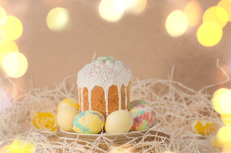 Cake with sprinkles and easter eggs. Easter cake by festive attributes. Easter composition with...