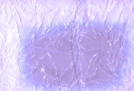 Violet cellophane transparent. Cellophane for packaging, product protection. White polyethylene texture. Violet  polyethylene bag textureの写真素材
