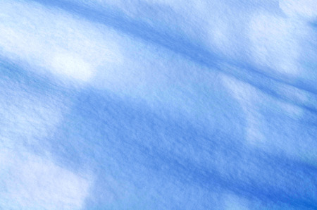 Snow texture in blue tone. Snowy nature winter backgroundの写真素材