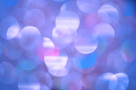 Abstract background with blue bokeh lights. Defocused blue lights background
