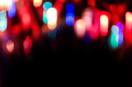 Defocused glowing street at night. Abstract motion blurred city view