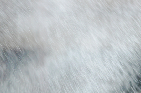 Snow bokeh texture background. Winter snow on blue sky and sun.の写真素材