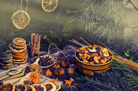 Dried oranges, cinnamon, anise and  fir branches christmas decoration on a dark toned background.の写真素材