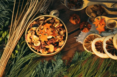 Dried oranges, cinnamon, anise and  fir branches christmas decoration on a dark toned background.の写真素材