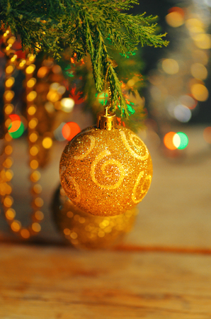 Christmas and New Year branch. Christmas gold decoration ornament background. Christmas gold ball on  fir branches.の写真素材