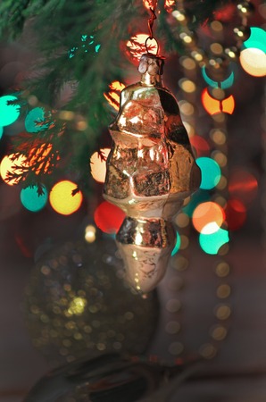 Fresh fir branches and gold ornaments macro. Christmas decorations and branches firの写真素材