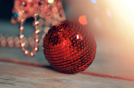 Red bauble on Christmas tree. Decorated Christmas tree. Red decorative ball on Christmas treeの写真素材