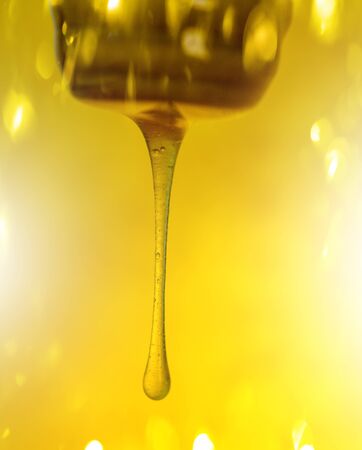 Organic sweet honey splashes. Honey dripping with honey dipper. Honey flows from dipper. Honey...