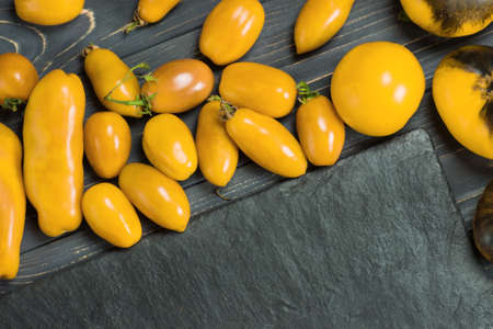 Variety ripe natural organic delicious tomatoes. Fresh seasonal locally grown yellow  vegetables. Group of fresh yellow tomatoes.の写真素材