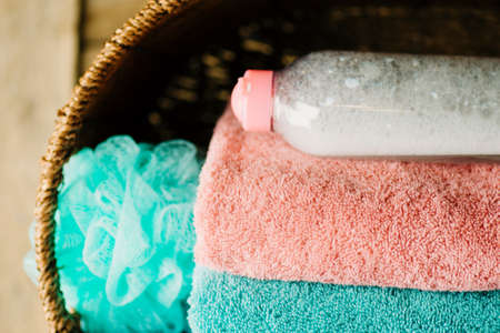 Stack of  towels, soap, washcloth, gel. Stack of bath towels on wooden backgroundの写真素材