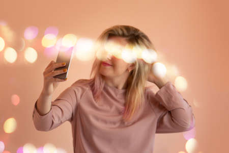 Portrait of  attractive lady making selfie. Happy beautiful young woman doing a selfie photoの写真素材