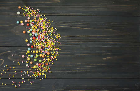 Colorful foam ball texture. Colorful foam ball on a black wooden background
