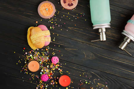 Natural cosmetics and soap on a black wooden background. Various personal care products. Various spa and body care products.の写真素材