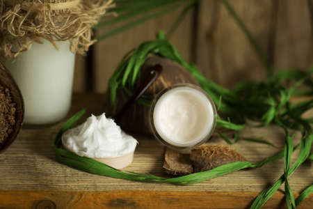 Coconut oil and coconut cream on old wooden table. Organic coconut products for spa.の写真素材