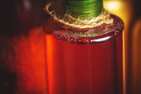 Red shampoo on wooden background close upの写真素材