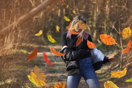 Beautiful woman in autumn landscape. Blonde dancer in colorful autumn park.