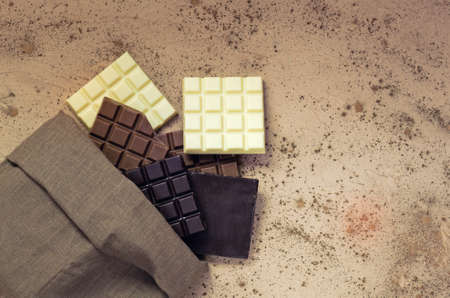 Chocolate candy bars. Chocolate bar pieces. Different milk and dark chocolate. Chocolate pieces on...