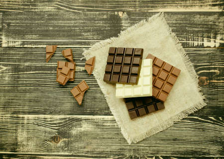 Different mix chocolate bars. Dark, milk and white chocolate bar. Chocolate over rustic wooden...
