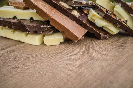 Various chocolate bar pieces. Dark, milk and white chocolate bar.