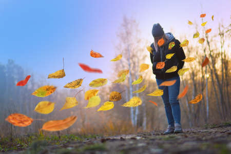 Sad woman walking away alone. Beautiful sad lonely girl walking away in autumn forest.