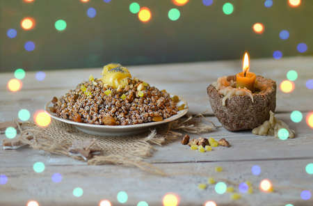 Christmas dessert Kutia on a modern table. Traditional Ukrainian food. Sweet Christmas dish in rustic clay bowl.の写真素材