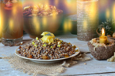 Kutya on Eve holiday. Christmas porridge with candles on wooden background.の写真素材
