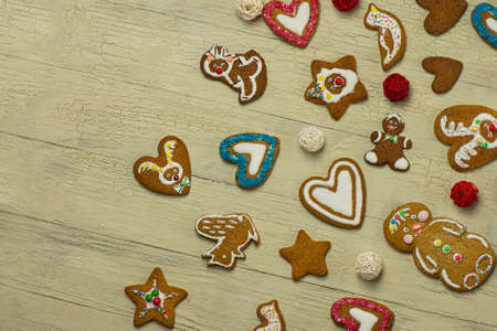 Homemade gingerbread cookies over white wooden table