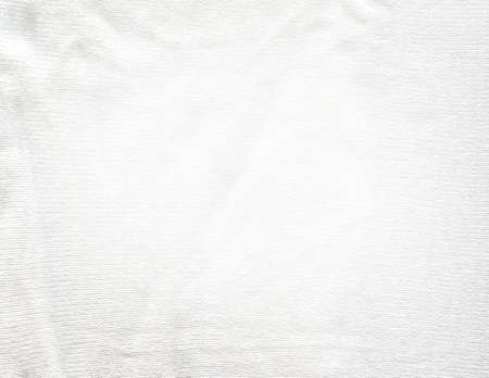 Warm white light knitted fabric flat lay. Warm handmade sweater made of white wool.の写真素材