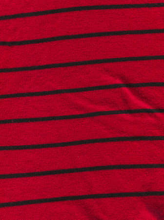 Magneta knitted background with copy space. Beautiful knitted purple burgundy colored wool textiles with black stripesの写真素材