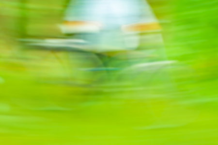 Motion blurred bokeh of riding cyclist illumination bokeh. Road bike conceptual blurred unfocus background.の写真素材