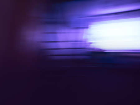 Blurry silhouettes of movie and video production in studio interior. Lights blurred bokeh making...
