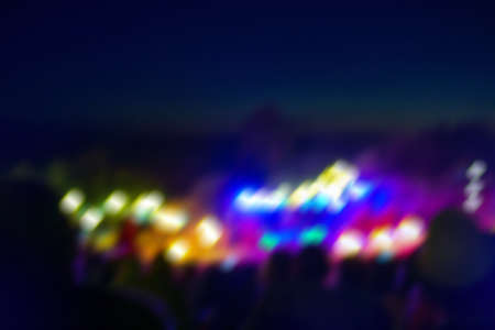 Trendy festival blurred bokeh texture during summer night. Blurred crowds on night music festival background.の写真素材