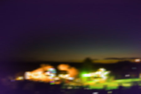 Excited guests up the front at night music festival Trendy festival blurred bokeh texture during summer night.の写真素材
