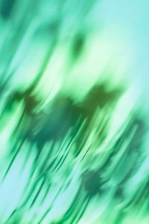 Green dynamic curving light trails. Green blurry defocused dynamic sparks flying background.の写真素材