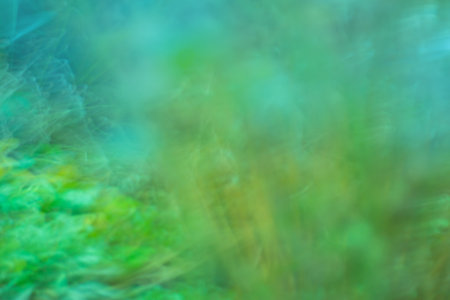Green defocused dynamic abstract background. long time exposure motion blurの写真素材
