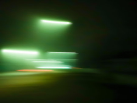 Blurry city skyline at night with defocused buildings. Life at blurred night modern city.