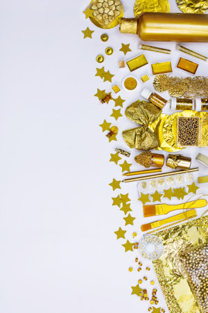 Frame border made of various golden color art and craft supplies. Bright golden color objects for creativity and art projects top view.の写真素材